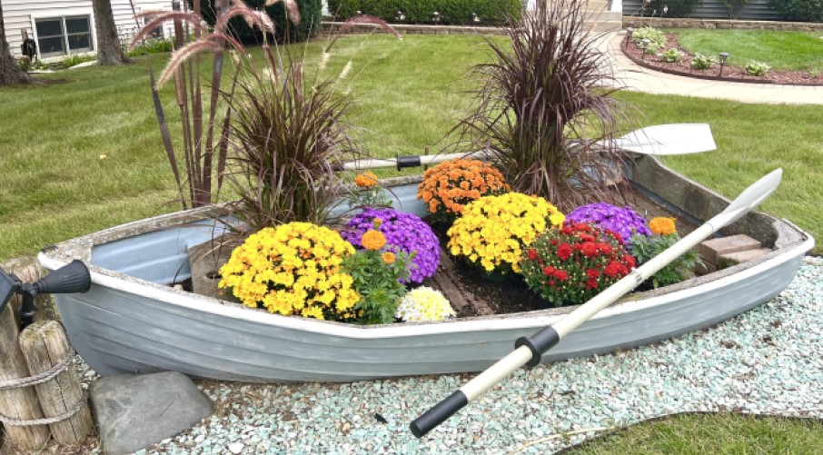 Garden boat with fall flowers and plants